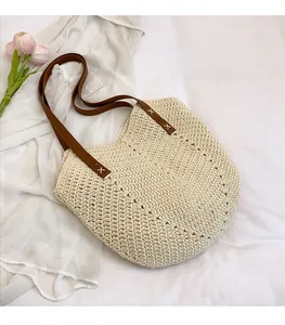Detailansicht der beigen Flecht-Tote-Bag mit braunen Ledergriffen und Kreuznaht-Design