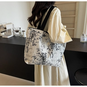 Detail of canvas tote with black ink bamboo prints and durable wide shoulder straps