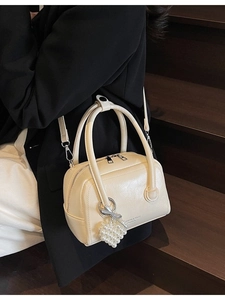 Elegant cream Boston pillow bag with pearl heart charm and slim adjustable strap
