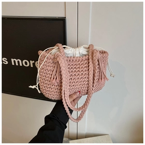 Detail of pink hand-woven cotton rope bucket bag with secure white canvas drawstring liner
