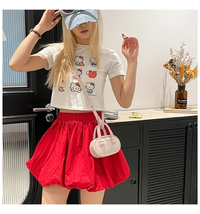 Pink mini oval crossbody bag styled with white printed tee and red bubble skirt