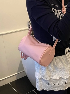 Pink lychee grain cylinder bag with silver zipper and shoulder strap for women