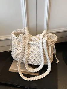 White woven bucket bag with braided handles and drawstring liner for summer beach style