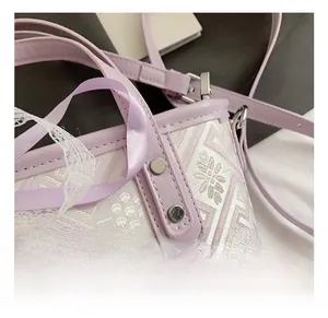 Detailed close-up of lavender jacquard fabric and metal hardware on a bucket bag