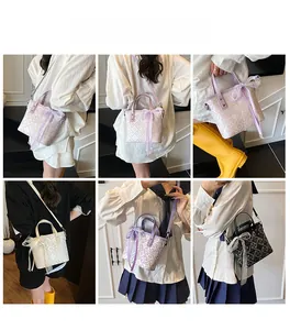 Detail view of woven texture and lace bow on mini bucket bags in purple, white and black