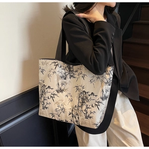 Detailed shot of large canvas tote bag with ink bamboo print shown on a model