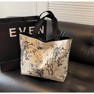 Detail of canvas tote bag featuring ink bamboo patterns and silk texture fabric