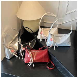 Selection of glossy faux leather shoulder bags in five colors with heart pendants