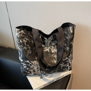 Detail of bamboo ink print on large black canvas tote bag with wide fabric handle