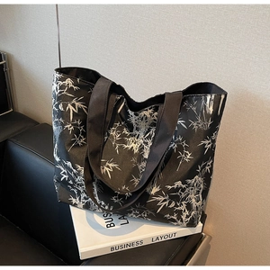 Detail of large canvas tote bag featuring black base and white bamboo forest art print