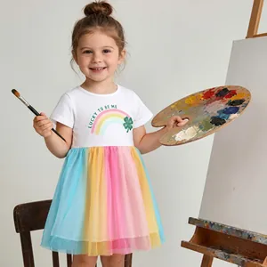 Detail of girls' rainbow tutu dress with clover print and Lucky to Be Me text graphic