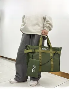 Detail of olive green nylon tote bag featuring white NOCO logo and matching coin purse