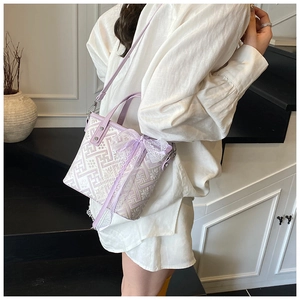 Detailed view of lavender crossbody bag with white lace trim and bow decorations