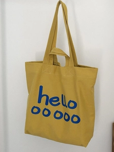 Grote gele canvas draagtas met blauwe hello print en verstelbare schouderbanden