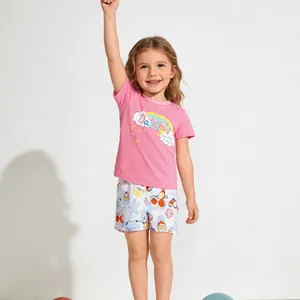 Detail of pink cotton summer set with rainbow print and short sleeves for young girls