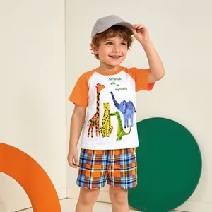 Detail of boys summer set with raglan sleeve animal print tee and plaid shorts
