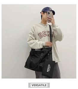 Model wearing large black nylon tote bag with white NOCO logo and matching small pouch