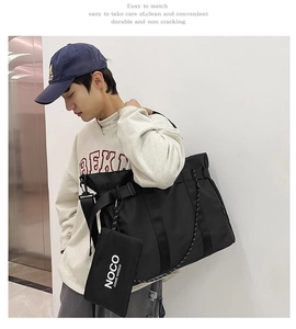 Detail of large black nylon tote bag with matching pouch shown on male model