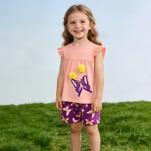 Detail of pink cotton t-shirt with ruffle sleeves and butterfly print on a child outdoor