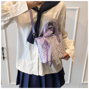 Detailed shot of purple New Chinese style bucket bag with floral embroidery and lace bow