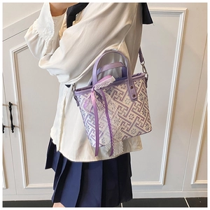 Detail of vintage geometric bucket bag with purple lace trim and satin ribbon accents