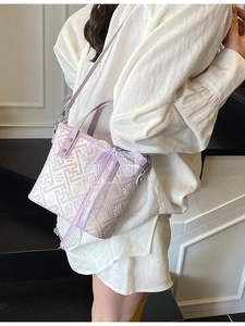 Chic purple bucket bag with white geometric patterns and lace bow accessory
