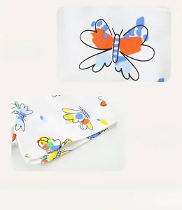 Detail of colorful butterfly prints and neat double-needle stitching on white cotton shorts