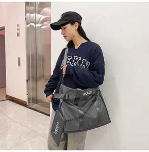 Detailed view of gray nylon tote bag with NOCO logo and matching small hanging pouch