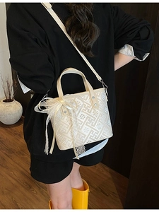 Elegant beige Chinese-style bucket bag with floral embroidery and lace bow details