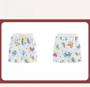 Detail view of girls' white cotton shorts with colorful butterfly prints and yellow drawstring