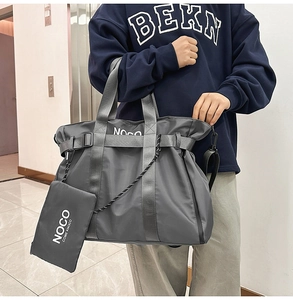 Detail of grey nylon tote bag with NOCO branding and matching accessory pouch