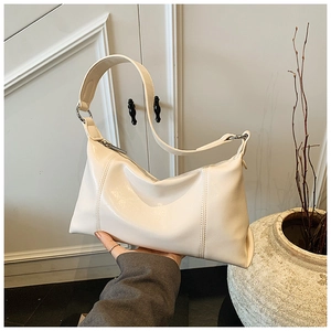 Detailed view of cream hobo shoulder bag with silver ring buckle and stitching