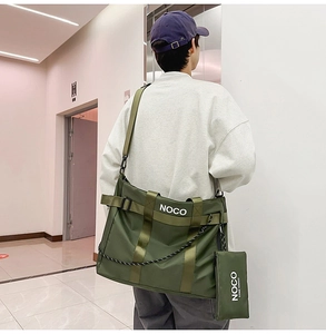 Detailed view of army green nylon tote bag with wide strap and side coin pouch