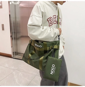 Detail of olive green nylon tote bag with NOCO print and matching zipper pouch