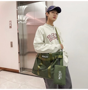Army green nylon tote bag with NOCO print and matching small pouch shown on model