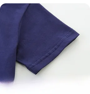 Detail of double-needle stitching on the cuff of a navy blue cotton dinosaur t-shirt
