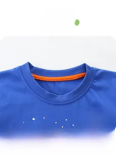 Detail of round neck with orange contrast binding and UFO print on cotton t-shirt