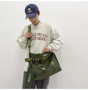 Detail of army green nylon messenger tote with a small pouch and white NOCO logo print