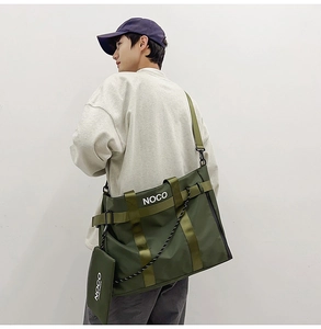 Detail of olive green nylon tote bag with wide strap and matching mini pouch