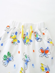 Girls' white cotton shorts with colorful butterfly print and yellow drawstring waist