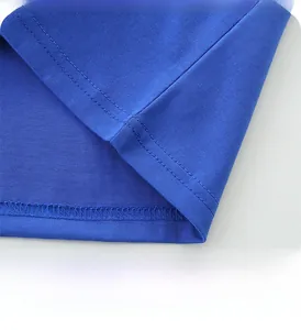 Detail of royal blue cotton T-shirt hem featuring professional double-needle stitching