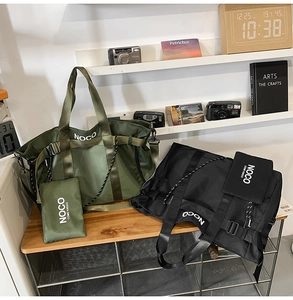 Army green and black nylon tote bags with matching pouches on a rustic wooden desk