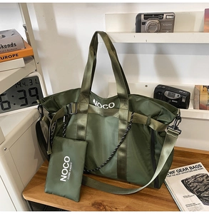 Detail view of army green nylon tote bag with matching small pouch and fabric shoulder strap
