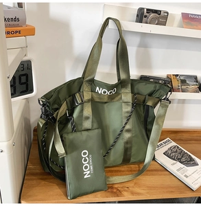 Detail of army green nylon tote bag with small detachable pouch and adjustable strap