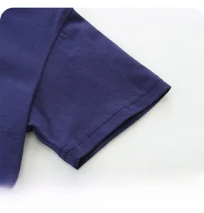 Detailed close-up of double-stitched cuffs on a navy blue cotton knit kid's t-shirt