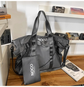 Close-up of dark grey nylon tote bag set on wooden table showing waterproof material detail