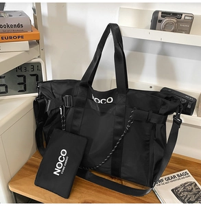Detail of nylon tote bag with NOCO logo, detachable strap and matching mini pouch