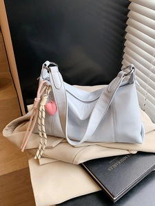 Chic light blue patent leather underarm bag with silver hardware and heart charm