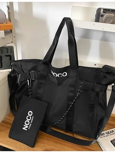 Large black nylon tote bag with small zipper pouch and adjustable strap for daily use