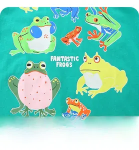 Macro detail of colorful cartoon frogs and Fantastic Frogs print on green cotton T-shirt